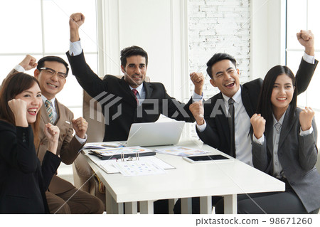 Success group of multiethnic entrepreneurs and business people achieving goals in corporate office, Colleagues cheering and smiling. Success group of multiethnic entrepreneurs and business people achieving goals in corporate office, Colleagues cheering and smiling. 98671260