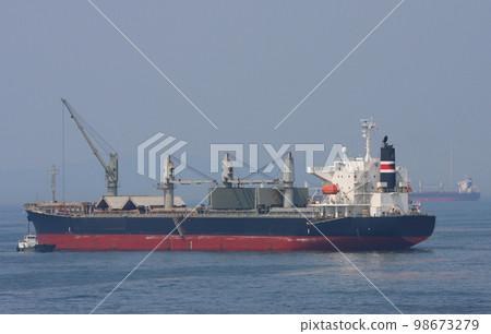 Bulk carrier with hatch covers fully open and half open Bulk carrier with hatch covers fully open and half open 98673279