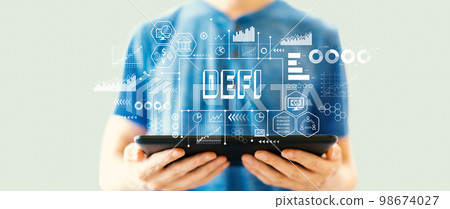 DeFi theme with man using a tablet 98674027