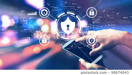Cyber security theme with person using a smartphone at night Cyber security theme with person using a smartphone at night 98674043