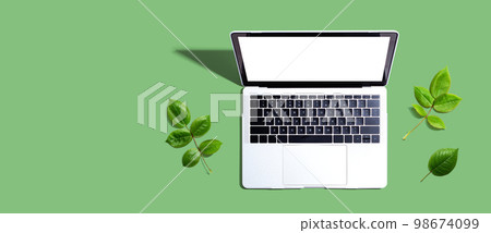 Laptop computer with green leaves Laptop computer with green leaves 98674099