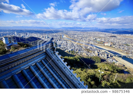 Gifu Prefecture, Gifu Castle's ridge-end tiles and the view of Gifu City (West direction, towards Mt. Ibuki) 98675346