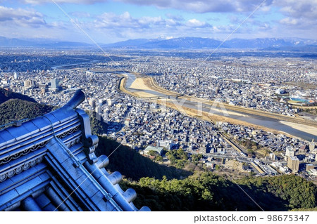 Gifu Prefecture, Gifu Castle's ridge-end tiles and the view of Gifu City (West direction, towards Mt. Ibuki) 98675347