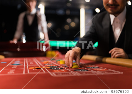 A man in a beard suit playing roulette 98676503