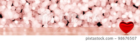 Wooden table and red heart, glittering light background 98676507