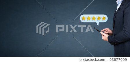 Businessman customer giving five star rating on phone.Customer Experiences Concept. Happy Client Using Smartphone to Submit Five Star Review Rating. Positive Feedback on Mobile Phone Businessman customer giving five star rating on phone.Customer Experiences Concept. Happy Client Using Smartphone to Submit Five Star Review Rating. Positive Feedback on Mobile Phone 98677009