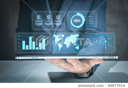 Businessman use tablet for analyze Environmental technology and approaching global sustainable ESG by clean energy and power. businessman hand with tablet and ESG text 98677014