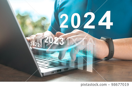 2024 new year. Business success and investment growth in 2024 years. man hand using laptop computer with virtual growth graph chart diagram, stock market, investment, digital technology, trading 2024 new year. Business success and investment growth in 2024 years. man hand using laptop computer with virtual growth graph chart diagram, stock market, investment, digital technology, trading 98677019