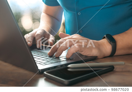Close-up partial view of businessman typing on laptop at workplace. businessman using laptop. Cropped image Searching browsing internet Data information Close-up partial view of businessman typing on laptop at workplace. businessman using laptop. Cropped image Searching browsing internet Data information 98677020
