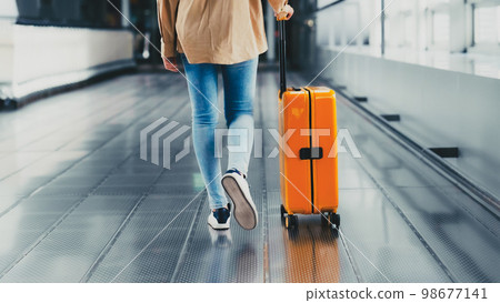International airport terminal. Asian beautiful woman with luggage and walking in airport 98677141