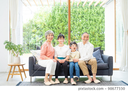 Senior couple and grandchild 98677330