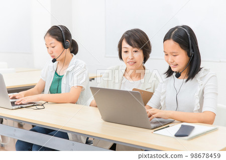 Teacher and child (girl/Japanese) who educates ICT using a personal computer Teacher and child (girl/Japanese) who educates ICT using a personal computer 98678459