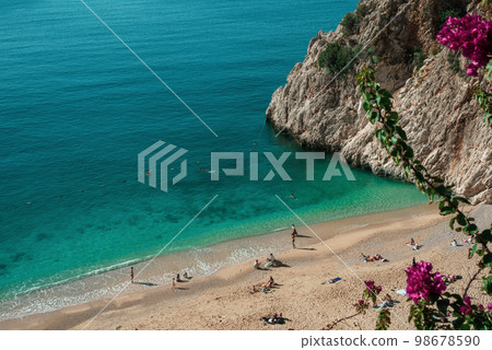 Beautiful Kaputas beach with bougainvillea flowers in the background. December. Turkey Antalya Kemer Beautiful Kaputas beach with bougainvillea flowers in the background. December. Turkey Antalya Kemer 98678590