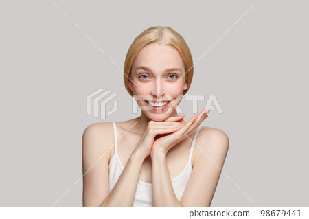 Portrait of beautiful woman with hands smiling. Beauty, cosmetics, skincare, glamour 98679441