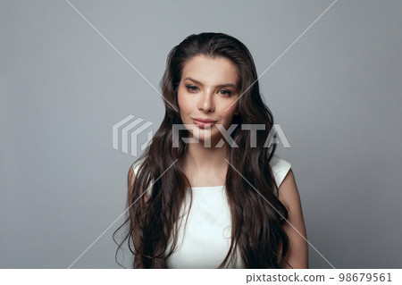 Brunette woman with long healthy curly hair, fashion portrait Brunette woman with long healthy curly hair, fashion portrait 98679561