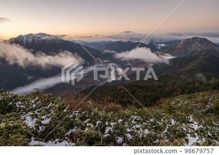 從日本阿爾卑斯山的山脊線看到的初冬北阿爾卑斯 雪堆積在山頂上 北阿爾卑斯的山脈被雪覆蓋 98679757