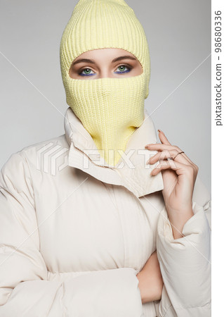 beautiful girl in yellow balaclava. Trendy Mask on pretty woman 98680336