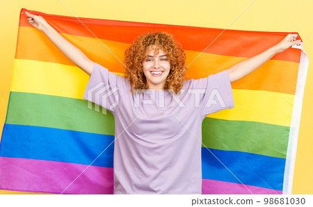 Happy woman waving a lgbt rainbow flag Happy woman waving a lgbt rainbow flag 98681030