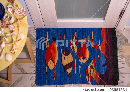 Nautical rug in front of the bathroom door 98681284