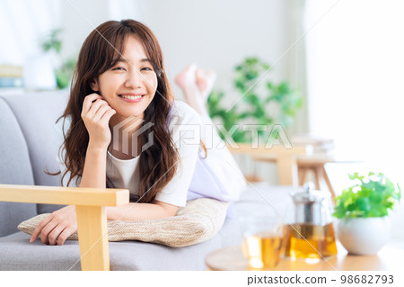 Lifestyle living room lying down woman 98682793