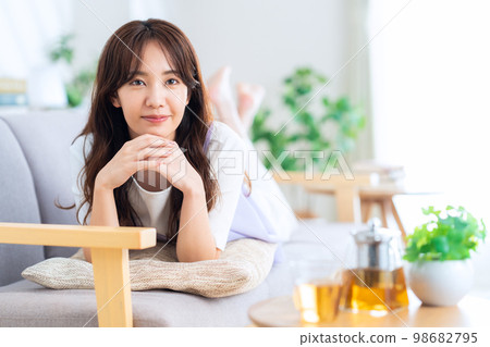 Lifestyle living room lying down woman 98682795