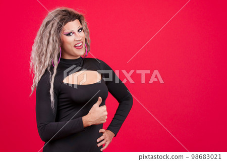 Transgender person with make up gesturing approval raising thumb up 98683021