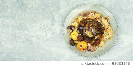 Pork knuckle cooked in sauerkraut, recipe place 98683146