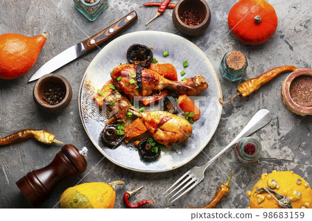 Chicken legs baked with pumpkin 98683159
