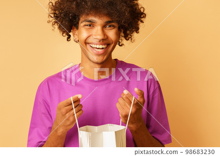 Happy smiling man with shopping bags in hand Happy smiling man with shopping bags in hand 98683230