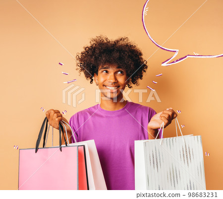 Happy smiling man with shopping bags in hand Happy smiling man with shopping bags in hand 98683231