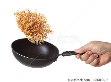 Instant Noodle fly in iron pan, yellow instant noodle float explode, abstract cloud fly. Curved dried instant noodles splash throwing in Air. White background Isolated high speed shutter, freeze Instant Noodle fly in iron pan, yellow instant noodle float explode, abstract cloud fly. Curved dried instant noodles splash throwing in Air. White background Isolated high speed shutter, freeze 98683696