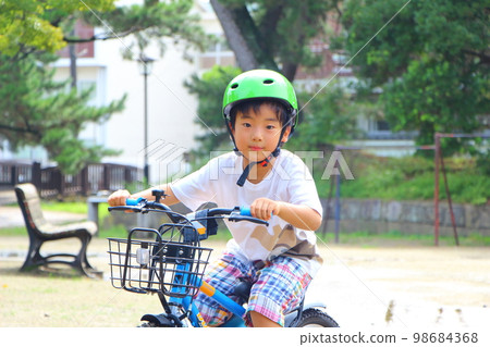 child riding a bicycle child riding a bicycle 98684368