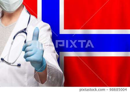 Norwegian doctor's hand showing thumb up positive gesture on flag of Norway background Norwegian doctor's hand showing thumb up positive gesture on flag of Norway background 98685004