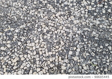 Grey white paving slabs. Background of the hiking trail. The texture of the stone. Grey white paving slabs. Background of the hiking trail. The texture of the stone. 98685445