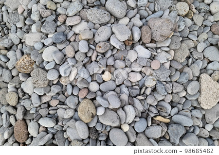 The texture of the stone on the beach. Pebbles, background stone. 98685482
