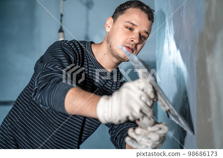 manual application of waterproofing to the wall on the construction site manual application of waterproofing to the wall on the construction site 98686173