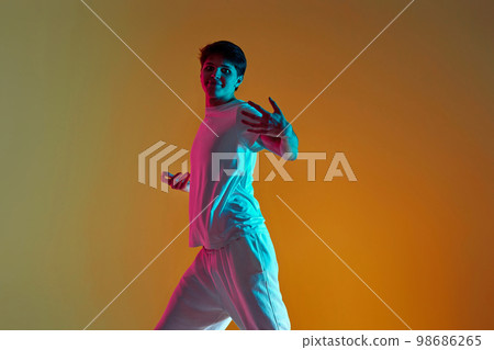 man dancing on yellow background. Neon lighting man dancing on yellow background. Neon lighting 98686265