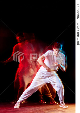 young man playing table tennis in mixed neon light 98686274