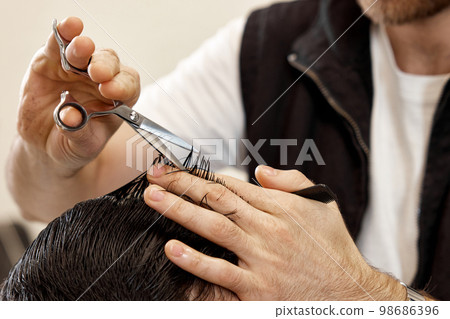 hairdresser does haircut for caucasian bearded man hairdresser does haircut for caucasian bearded man 98686396