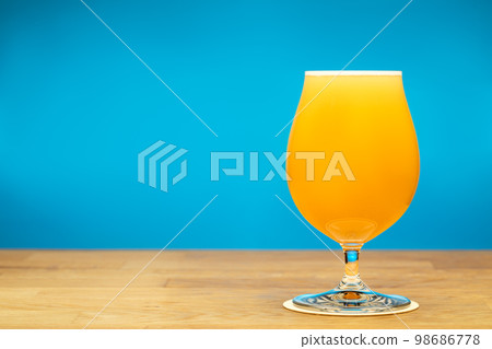 Full tulip glass of NEIPA beer on a table 98686778
