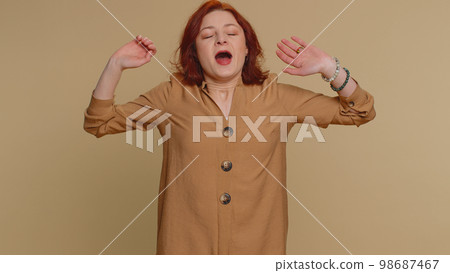 Tired sleepy redhead woman yawning, feeling somnolent lazy bored gaping suffering from lack of sleep Tired sleepy redhead woman yawning, feeling somnolent lazy bored gaping suffering from lack of sleep 98687467