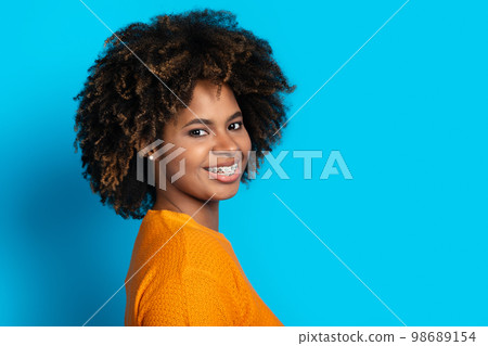 Profile portrait of cheerful african lady isolated on blue 98689154