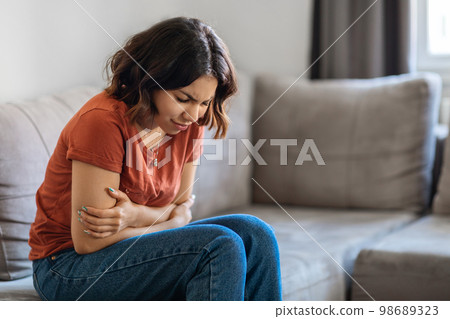 Depression Concept. Sad Young Arab Woman Sitting On Couch At Home Depression Concept. Sad Young Arab Woman Sitting On Couch At Home 98689323