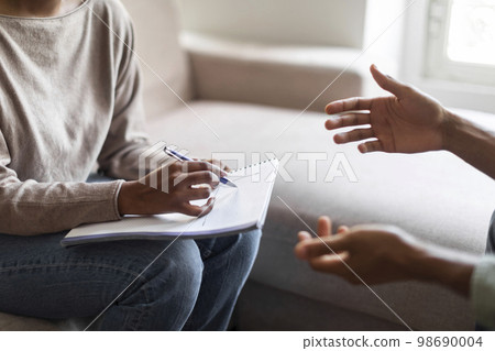 Therapist holding folder, pen and man patient hands, psychological help Therapist holding folder, pen and man patient hands, psychological help 98690004