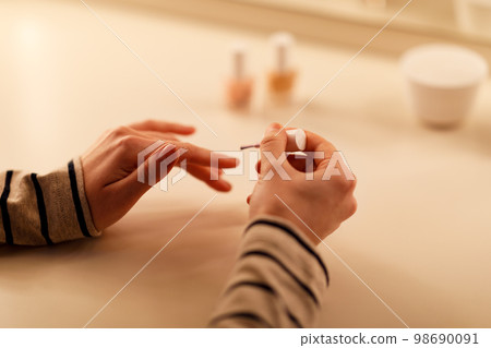 Cropped of lady doing manicure at home 98690091