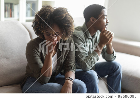 Upset black woman crying after quarrel with husband 98690093