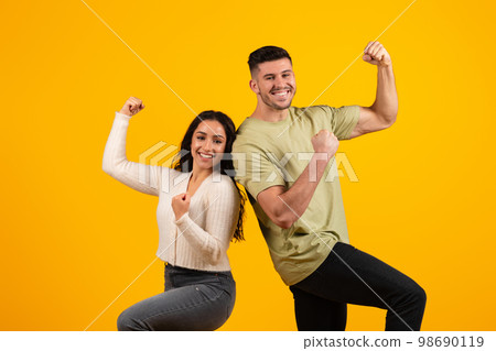 Cheerful excited young arabic couple in casual make gesture of success and victory, rejoice together Cheerful excited young arabic couple in casual make gesture of success and victory, rejoice together 98690119