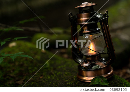 Antique lantern placed near the river 98692103