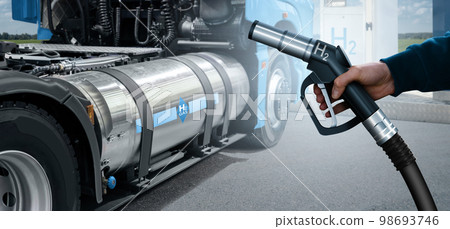 Hand with H2 nozzle on a background of hydrogen fuel cell semi truck 98693746