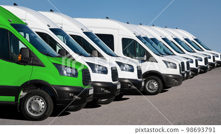 Delivery vans in a row. One van green. 98693791